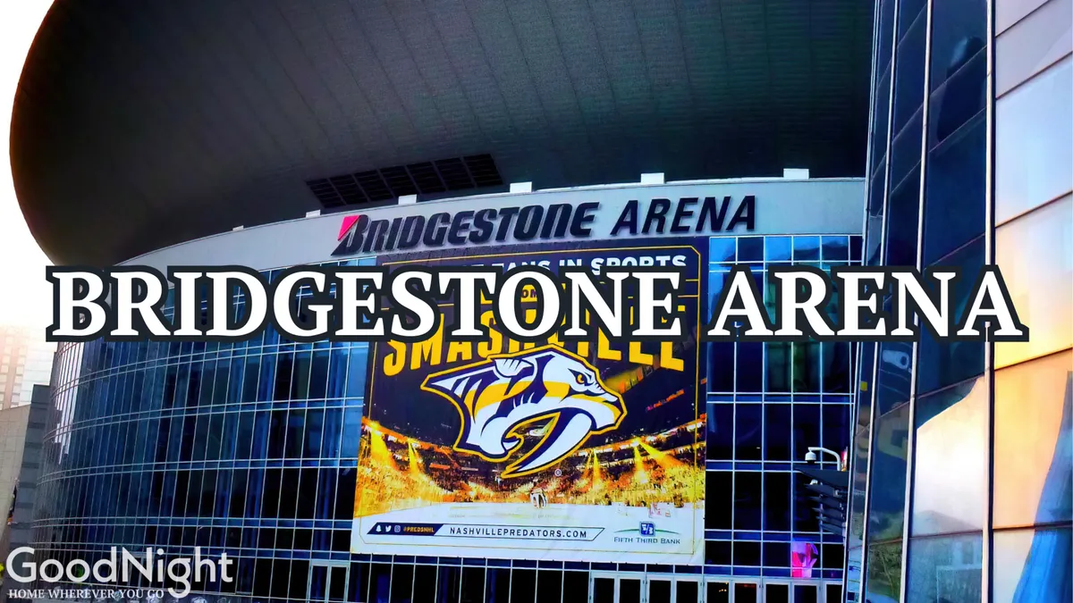 The exterior of Bridgestone Arena, featuring its prominent signage, the Nashville Predators logo, and a large promotional event banner. The arena is surrounded by energy and excitement, with hints of crowds gathering for sports or concerts.