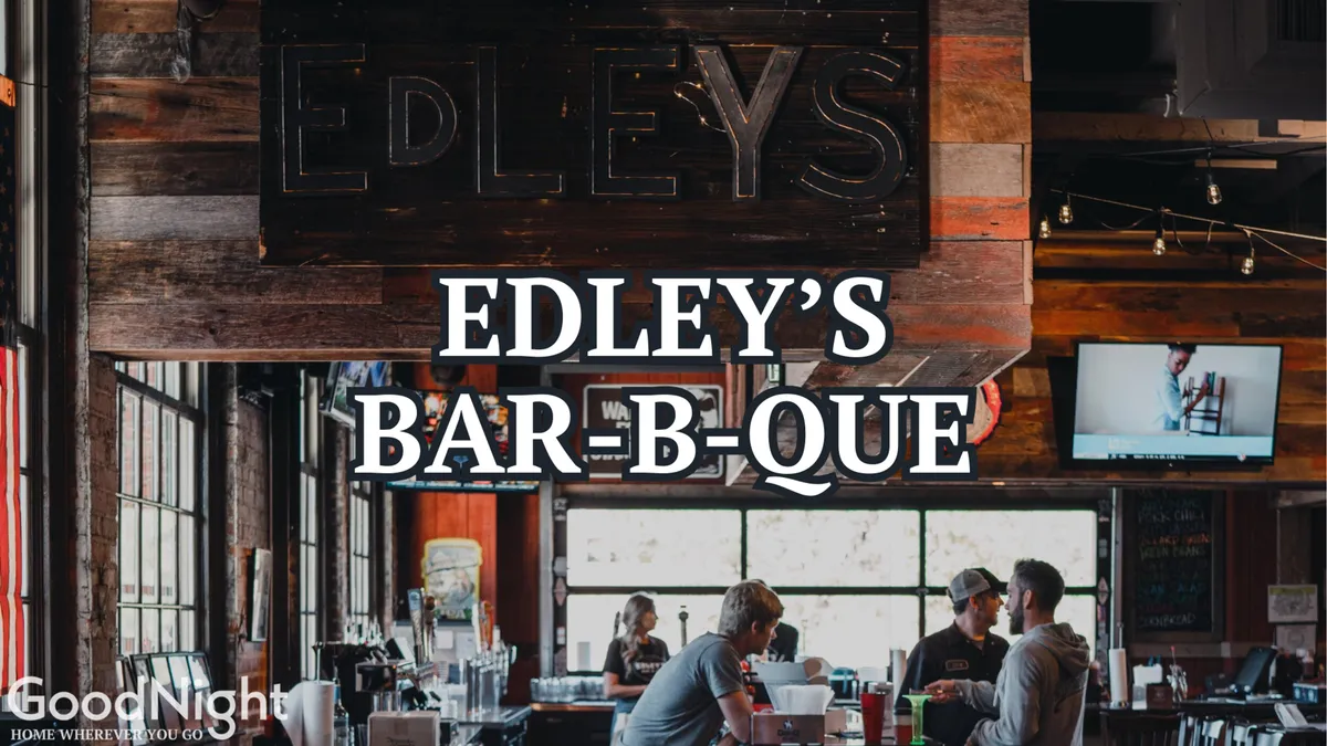 The interior of Edley’s Bar-B-Que, showcased with its signature signage, a lively bar area, and patrons enjoying hearty barbecue in a warm, communal space. The friendly ambiance and visible dishes in the foreground invite viewers to imagine themselves savoring authentic local flavors.